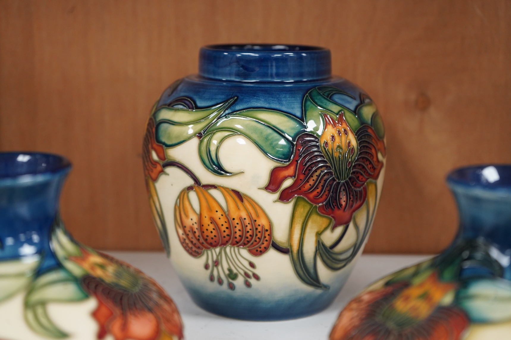 Two modern Moorcroft vases and a jar in the Anna Lily pattern, largest 14cm high